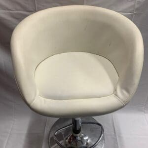 A white chair with a chrome base and a round seat.