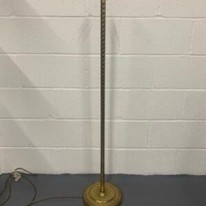 A floor lamp with a metal base and a light bulb.