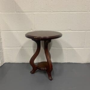 A small wooden table with two legs on the floor