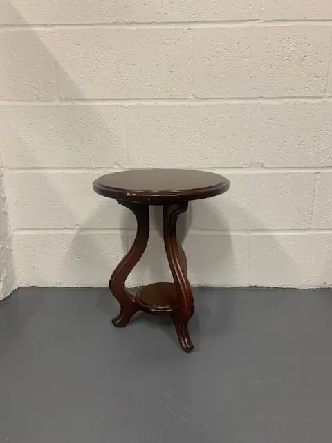 A small wooden table with two legs on the floor