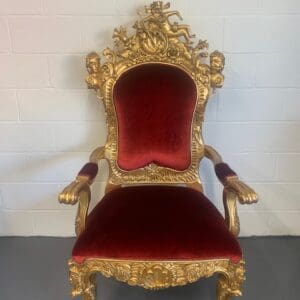 A red and gold chair with arms on the back.