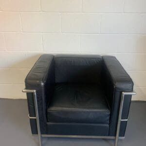 A black leather chair in an empty room.