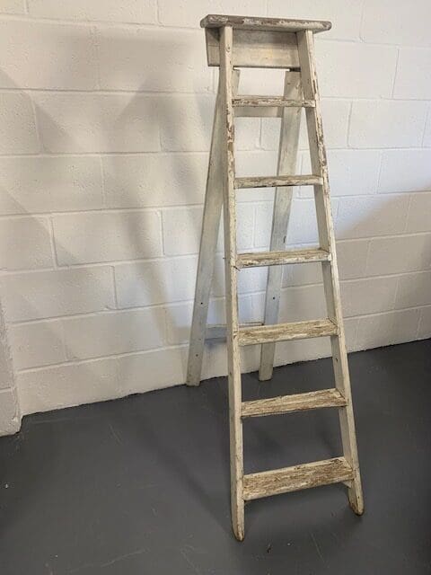 A ladder leaning up against the wall