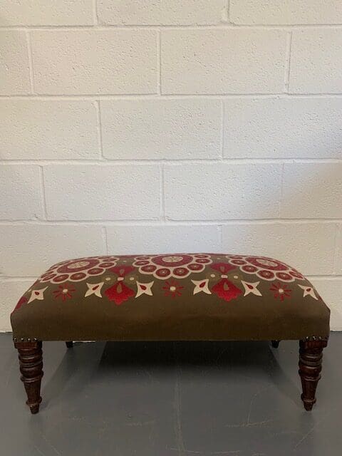 A bench with a brown and red pattern on it.