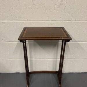 A small table with a brown leather top.