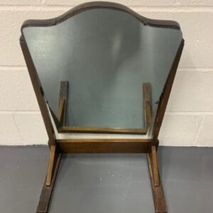 A wooden chair with a mirror on the back.