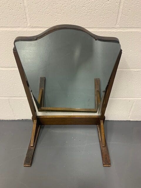 A wooden chair with a mirror on the back.