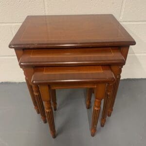 A set of three wooden tables sitting on top of each other.