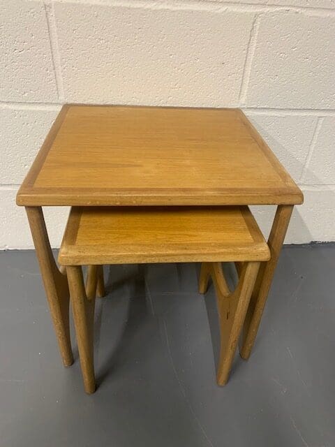 A pair of wooden tables sitting on top of each other.