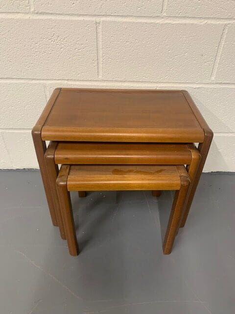 A set of three wooden tables sitting on top of each other.