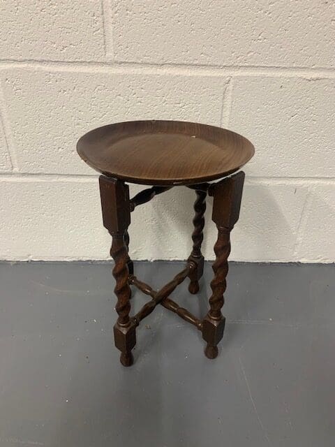 A small wooden table with a metal tray on top.