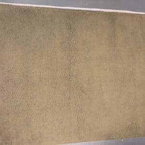 A beige carpet with some brown lines on it