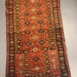 A rug with a red and brown pattern on it.