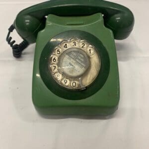 A green phone sitting on top of a table.