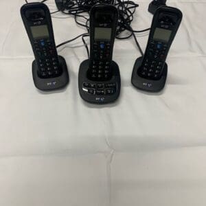 A group of three black phones on top of a table.