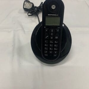 A motorola flip phone sitting on top of a black stand.