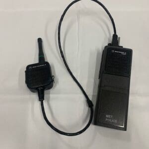 A black walkie talkie is connected to the same wire.