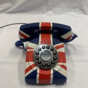 A british flag telephone is sitting on top of the table.