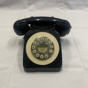 A black and white telephone on top of a table.