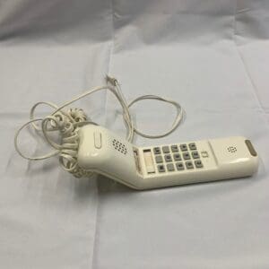 A white phone sitting on top of a table.