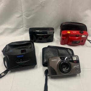 A group of cameras sitting on top of a table.