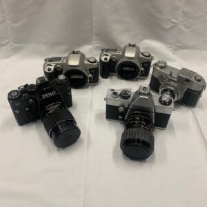 A group of cameras sitting on top of a table.