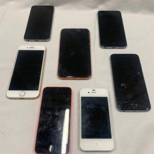 A group of six iphones sitting on top of a table.