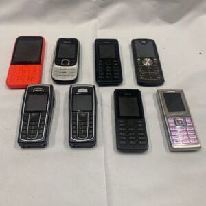 A group of cell phones sitting on top of a table.