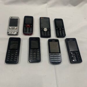 A group of cell phones sitting on top of a table.