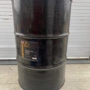 A black barrel sitting on top of the ground.