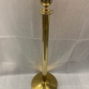 A gold colored pole with a ball on top.