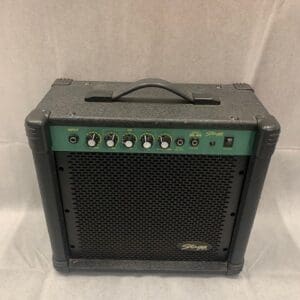 A black and green guitar amp sitting on top of a table.