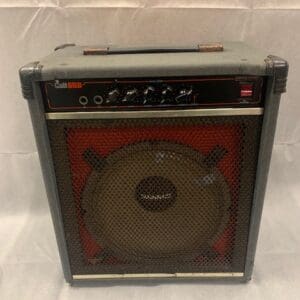 A red and black guitar amp sitting on top of a table.