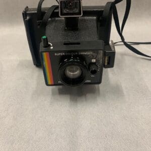 A polaroid camera with the front of it open.