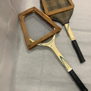 Two tennis rackets are sitting on a table.