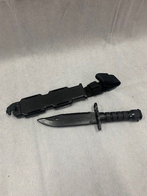 A knife and sheath are on the table.