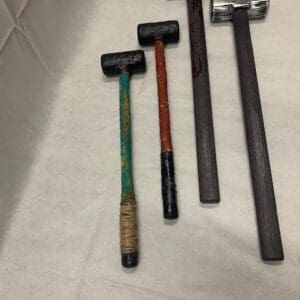 A group of hammers sitting on top of a counter.