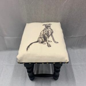 A stool with a picture of a cat on it.