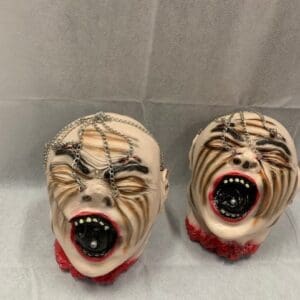 Two ceramic heads with faces painted on them