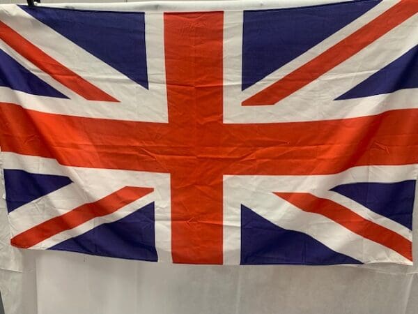 A flag of the united kingdom hanging on a wall.