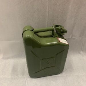 A green metal can sitting on top of a table.