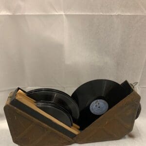 A wooden box with two records on top of it.