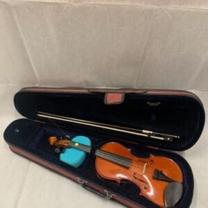 A violin in its case with the bow out.