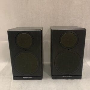 A pair of speakers sitting on top of a table.