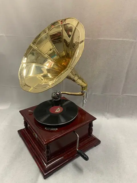 A record player with a gold plated horn.