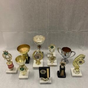 A group of trophies sitting on top of white marble.