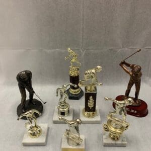 A group of trophies sitting on top of marble bases.