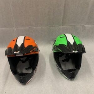 Two helmets are sitting on a table.