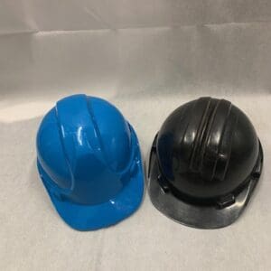 Two hard hats are sitting on a table.