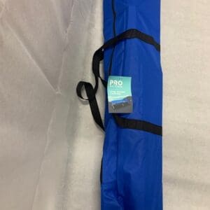 A blue bag with a black strap and a cell phone